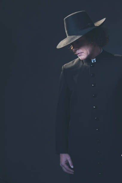 istock Mysterious victorian man in hat and black coat. 1142361805