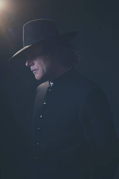 istock Mysterious victorian man in hat and black coat. 1142361813