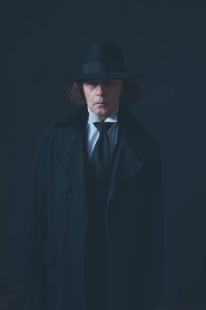istock Mysterious victorian man in black coat and hat. 1142361860