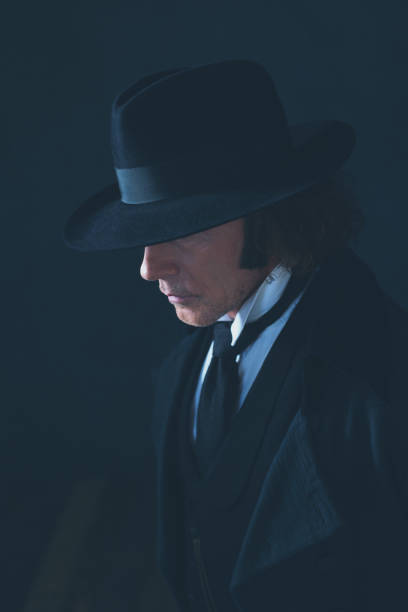 istock Mysterious victorian man in black coat and hat. 1142361867