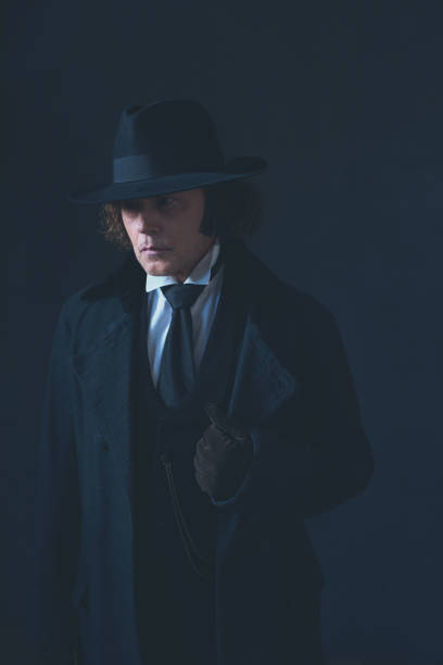 istock Mysterious victorian man in black coat and hat. 1142361868