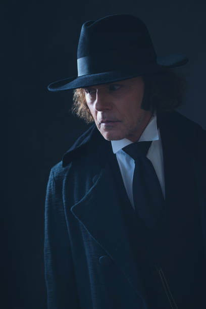 istock Mysterious victorian man in black coat and hat. 1142361880