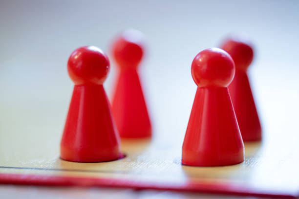 istock Playing a parlor game: Meeples on a table, ludo 1142363238