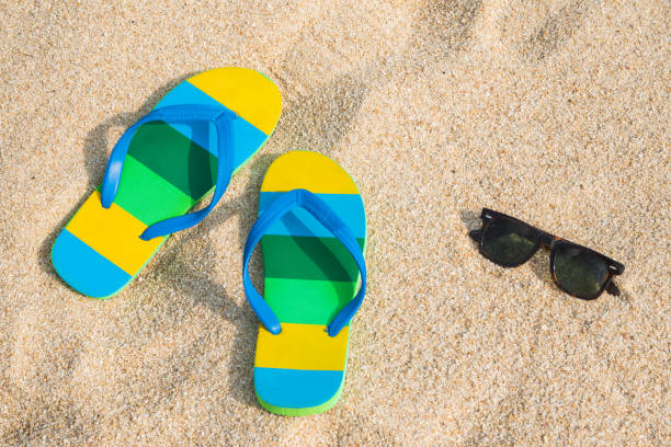 istock Beach sandals on the sandy coast. Summer concept with copy space. 1142363386