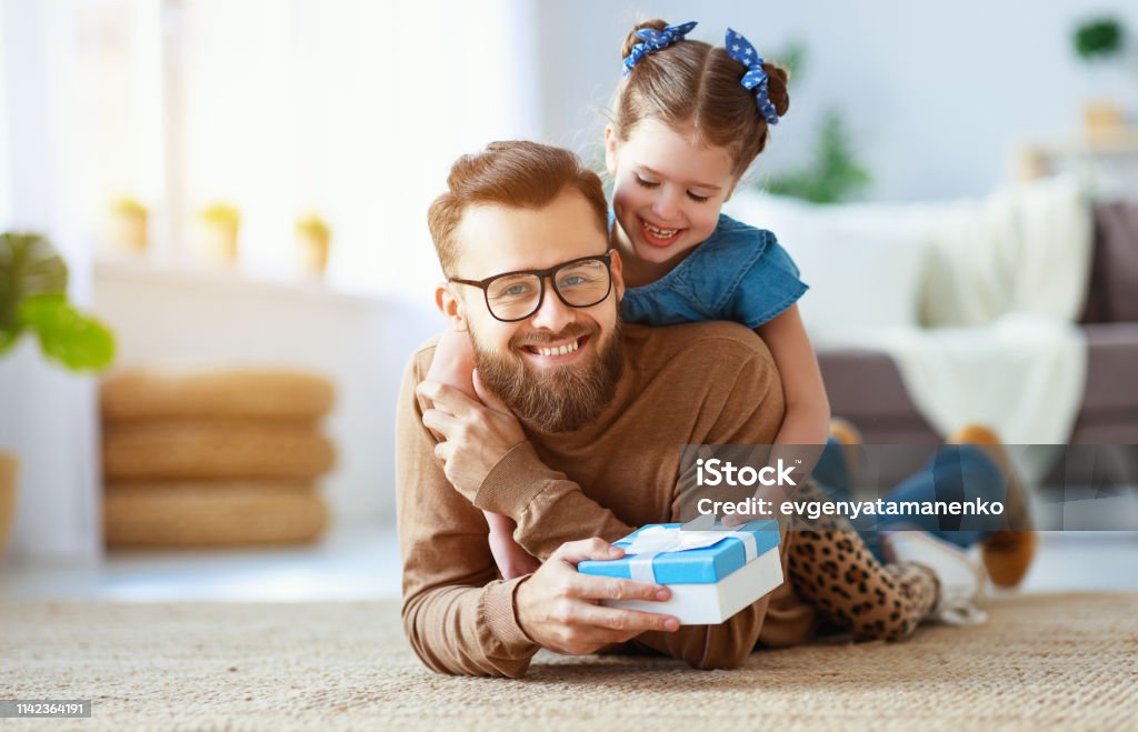 Father's day. Happy family daughter hugging dad and laughs Father's day. Happy family daughter hugging dad and laughs on holiday Father's Day Stock Photo