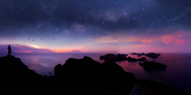 man standing on the mountain with panorama view and million stars galaxy - climbing men sea cliff imagens e fotografias de stock