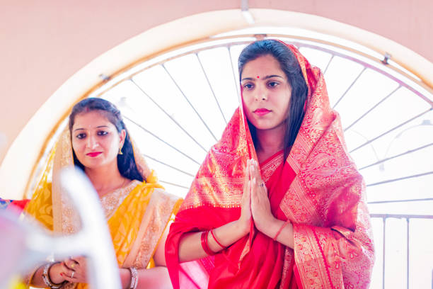 istock Indian Women Praying at a Temple 1142365394