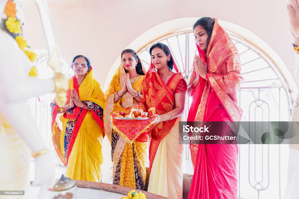 Group of Indian Women Praying at the Temple Portrait, Indian, Hindu, Celebration - A Group of Religious Women Performing Hindu Prayer Routines at a Temple Navratri Stock Photo