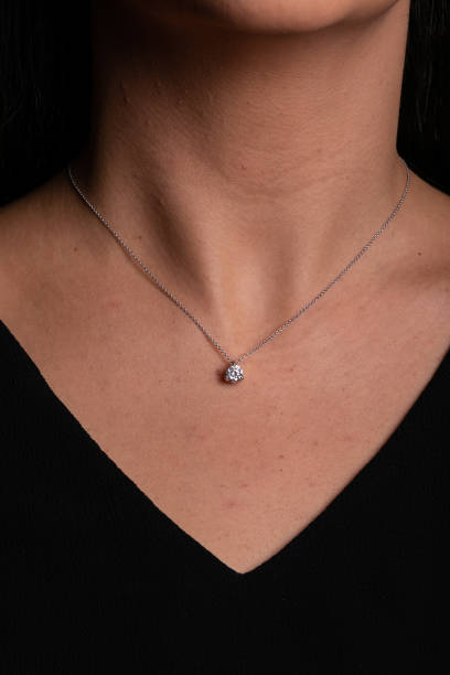 istock Silver chain with a pendant  with a stone in the middle hanging around his neck. 1142371446