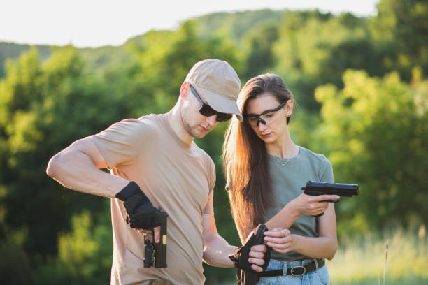 istock the instructor teaches the girl to shoot a pistol at the range 1142373708