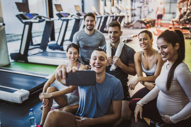 istock Happy athletic friends taking a selfie on a break in a gym. 1142374066