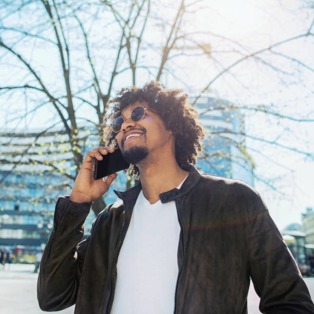 istock Man walking in the city and talking on mobile phone 1142376548