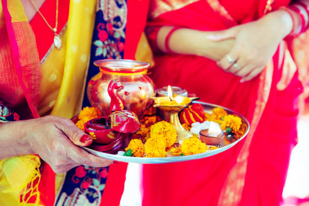 Senior Woman Holding Hindu Prayer Items on a Tray Hindu, Women, Faith, Devotion, Festival - Women Holding a Tray Containing Prayer Articles for Hindu Prayers at a Temple ganesh chaturthi photos stock pictures, royalty-free photos & images