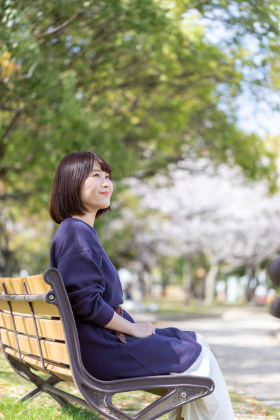 istock Woman relaxing on the bench 1142381373