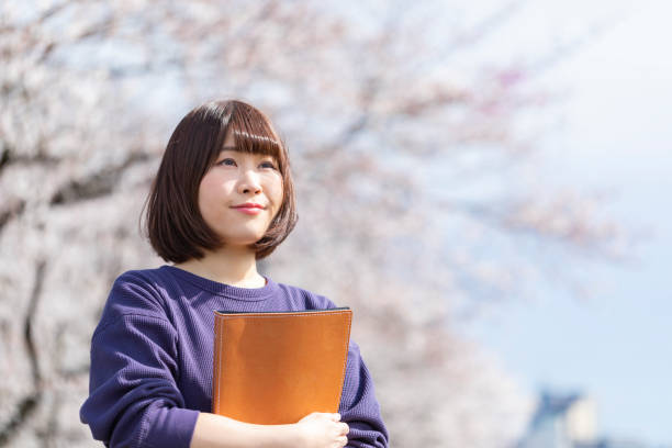 istock Cherry blossoms and women 1142381594