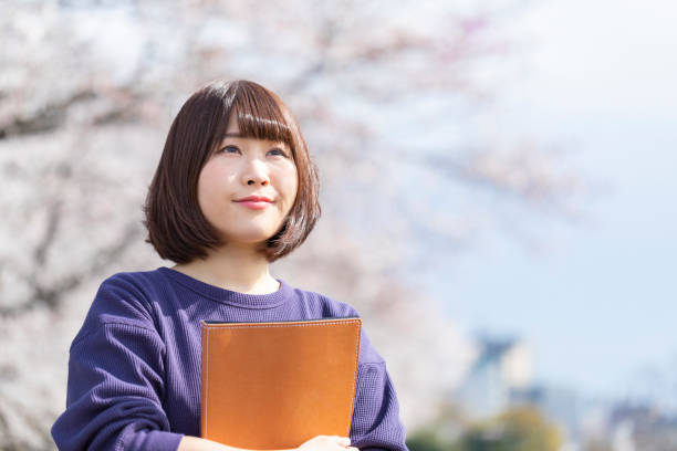 istock Cherry blossoms and women 1142381625
