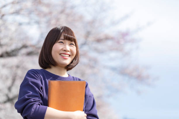 istock Cherry blossoms and women 1142381659