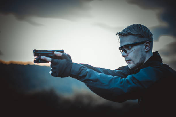 istock instructor with gun in forest leads aiming and posing on camera 1142381946