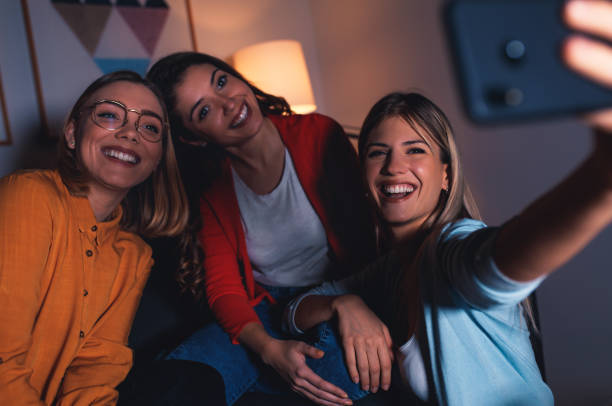 istock Three female friends chatting and making selfie at home. 1142384108