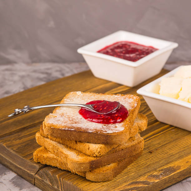 istock Simple breakfast of traditional products - toast with butter and raspberry jam 1142384802