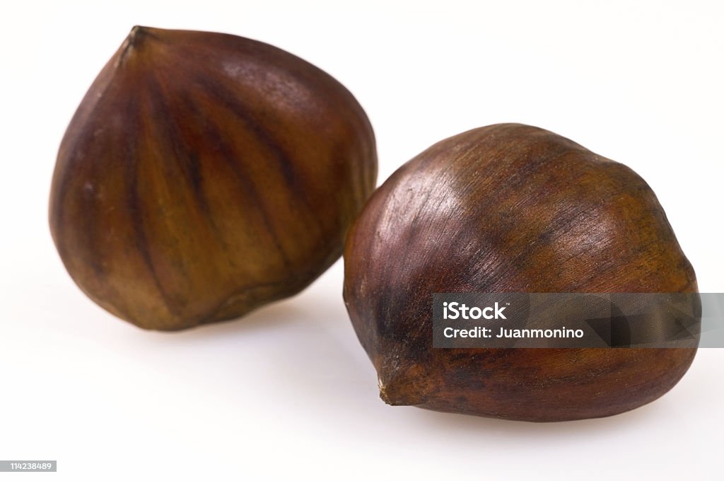 Two chestnuts against a white background  Chestnut - Food Stock Photo