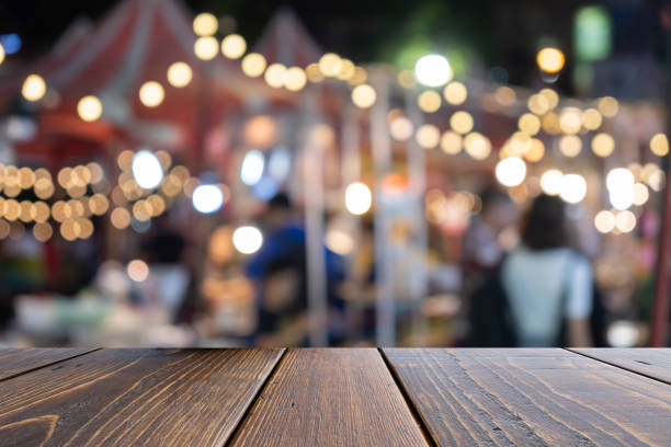 istock Empty wooden table on front blurred traffic bokeh background, for presentation and advertising product 1142386499