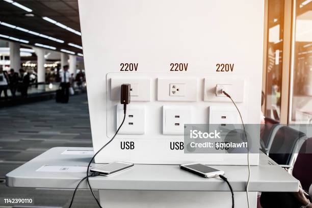 Travelers Use Smartphone For Charger Corner Free Charge Appliances And Electronics Equipment Phones Notebook Usb 220v Socket Providing Tourists And Travelers At Airport Thailand Stock Photo - Download Image Now