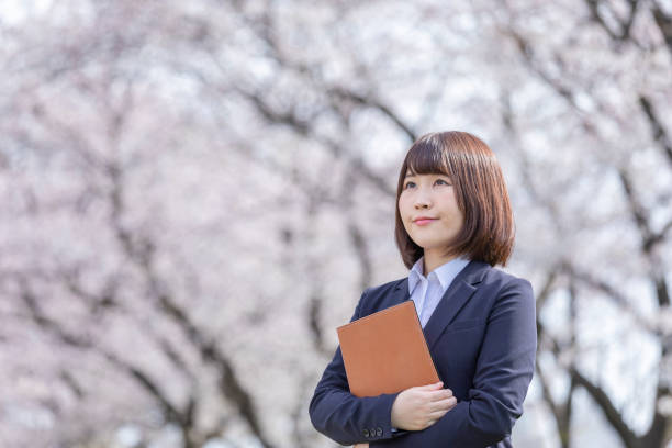 istock Woman in suit and cherry blossom 1142390185