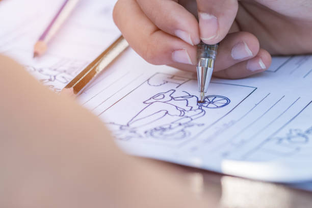 istock Hands drawing storyboard animation comic for pre-production process, design creative story scene layout in movie carton at studio. Behind making work before production film or video presentation 1142390308
