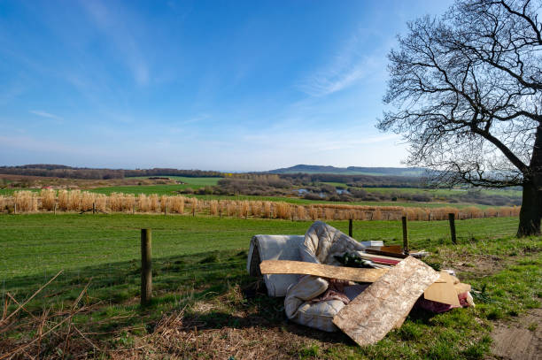 Fly Tipping Christmas Tree, Double Mattress, Timber, Furniture, Carpets and General Household Waste 3 Fly Tipping Christmas Tree, Double Mattress, Timber, Furniture, Carpets and General Household Waste in a Beautiful Scenic Rural Area over looking Farms and garbage dump stock pictures, royalty-free photos & images