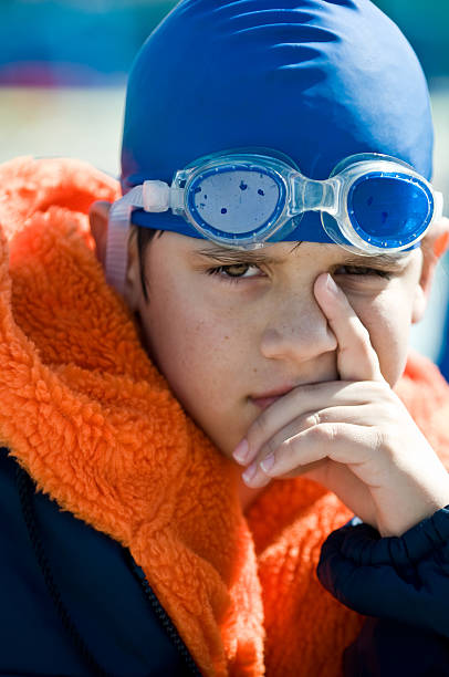 istock Young swimmer with swimming cap and goggles close up. 114239402