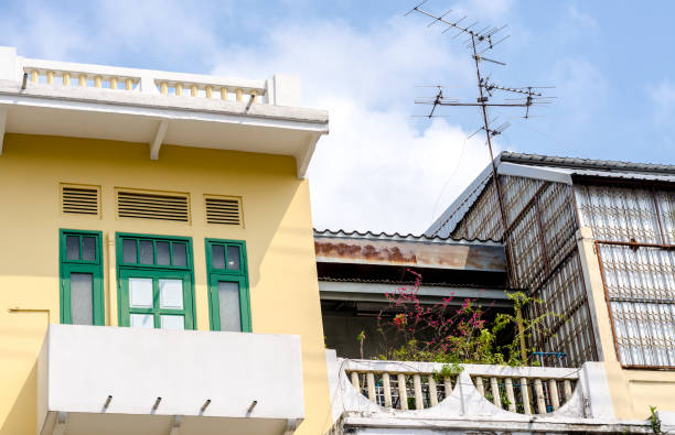 istock Old looking yellow wall and the old building 1142394022