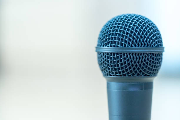 istock Interview: Black microphone is standing on the desk, copy space. 1142396095