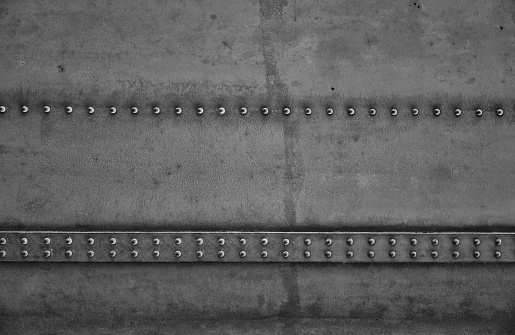 Close-up of a massive construction of a bridge. which gets its stability with steel rivets. Industrial style as design elements such as backgrounds.