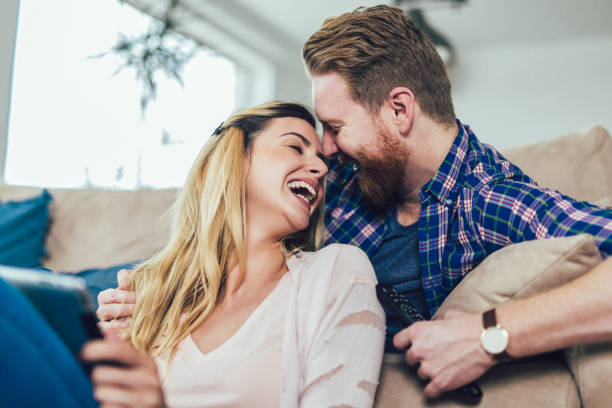 istock Couple in love sitting on the sofa and using tablet, having fun. 1142396637