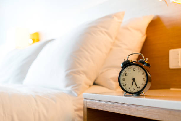 istock Metal Alarm clock on white bedroom 1142396731