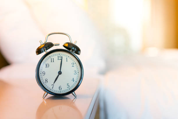 istock Metal Alarm clock on white bedroom 1142396735