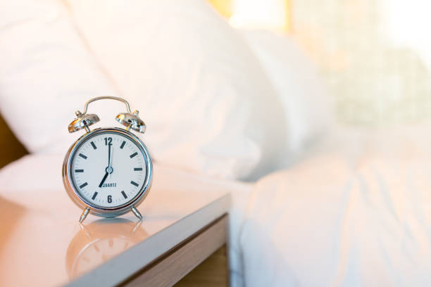 istock Metal Alarm clock on white bedroom 1142396740