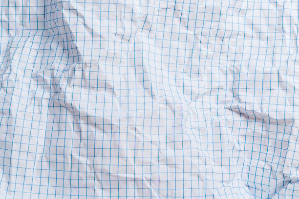 A sheet of folded and torn blue squared paper