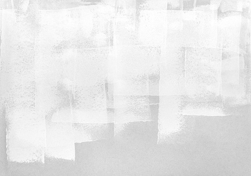 trazos de rodillo de pintura blanca sobre papel gris photo