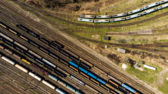 Cargo trains close-up. Aerial view of colorful freight trains on the railway station.  Top view from flying drone