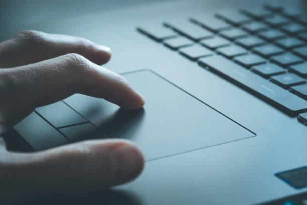 Close up picture of hands using a notebook touchpad