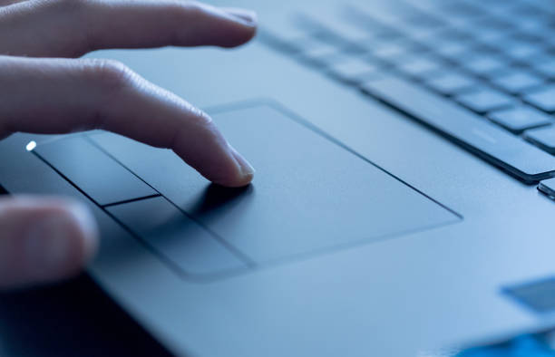 istock Hands are using a touchpad of laptop, close up picture 1142403524