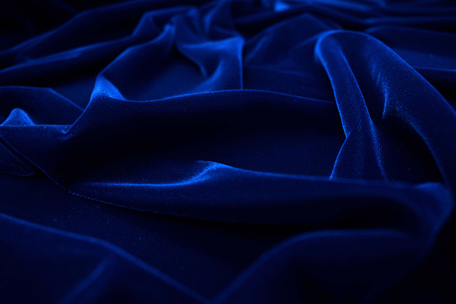 Dark blue velvet fabric texture background.
