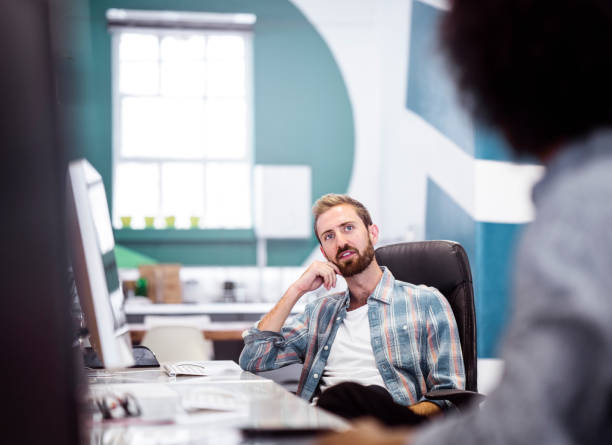 istock Serious businessman discussing with coworker in office 1142403714