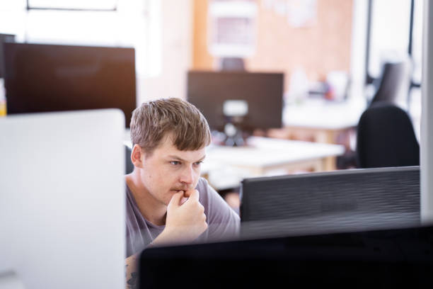 istock Serious young businessman staring at desktop PC 1142403807