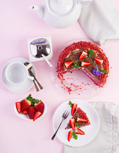 istock Red velvet cake on a pink background. Tea drinking. Table setting. Top view 1142404684