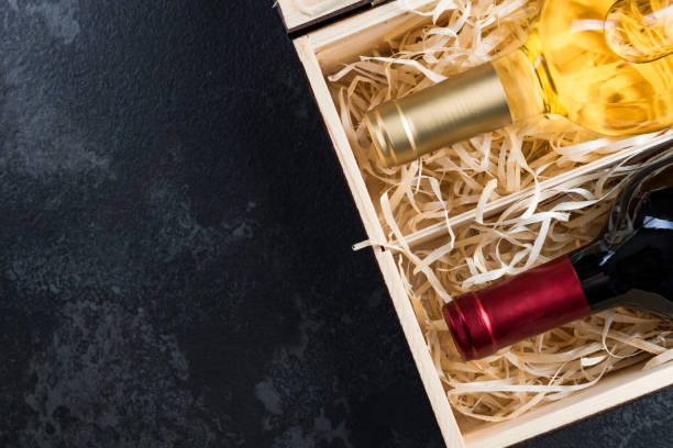 istock Red and white wine bottles in wooden crate 1142404756