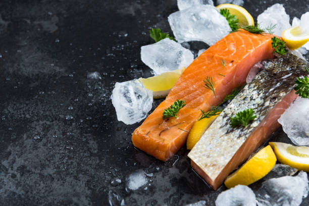 istock Salmon fillets with herbs, border background 1142406104