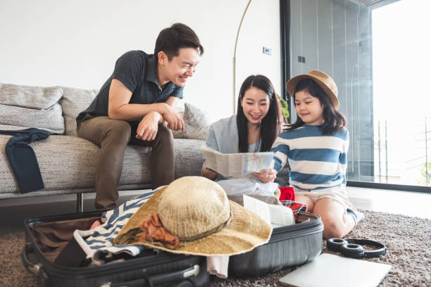 aziatische familie verpakking zak/bagage en van plan om te reizen op de zomervakantie - reizen in azië stockfoto's en -beelden